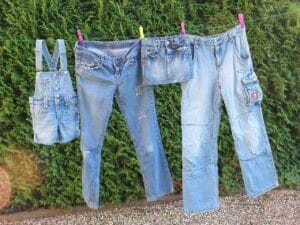 Different styled jeans airdrying on a clothing line